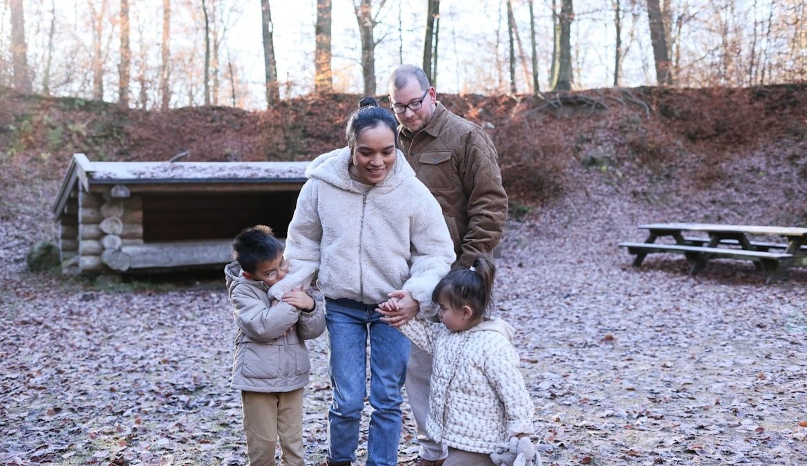 Family walking together in a forest clearing